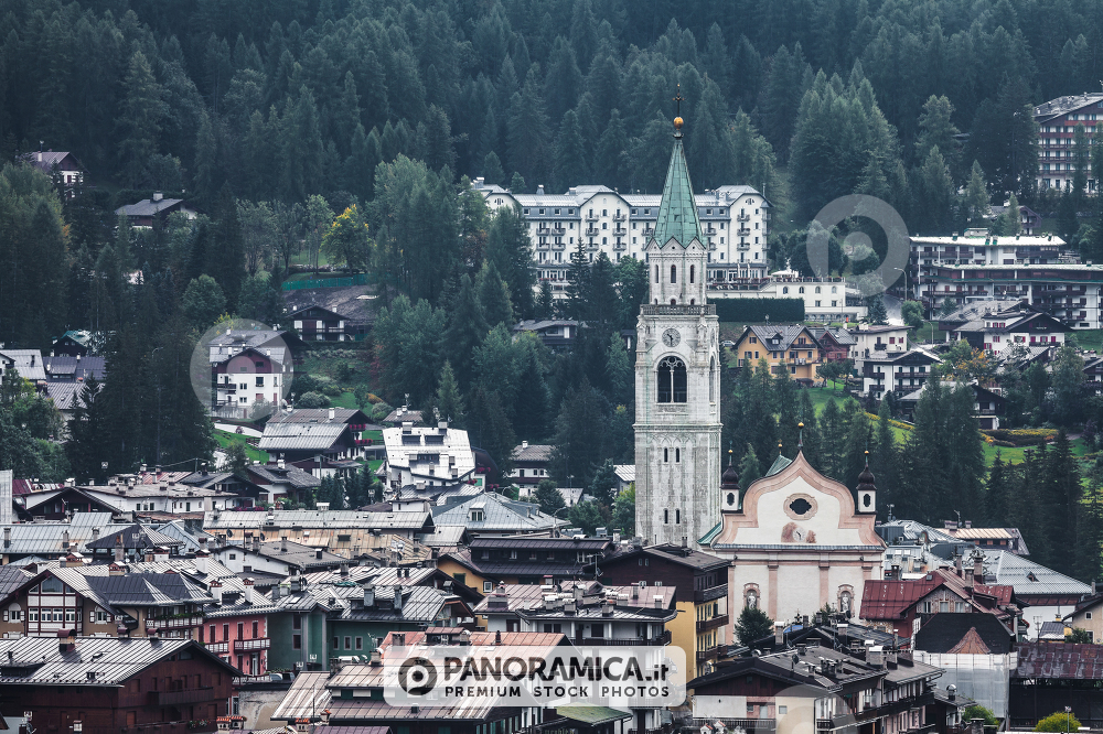 A view of the bell tower of Cortina d'Ampezzo from an high valley, Veneto, Dolomites, Italy