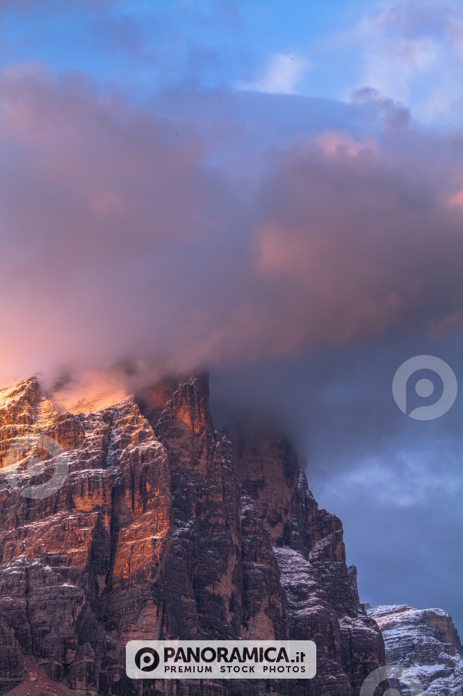 Alpenglow and clouds highlighting Tofana di Rozes, Cortina d'Ampezzo, Dolomites, Veneto, Italy