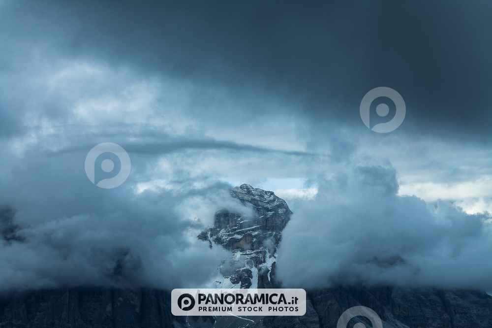 Alpenglow and clouds highlighting Tofana di Rozes, Cortina d'Ampezzo, Dolomites, Veneto, Italy