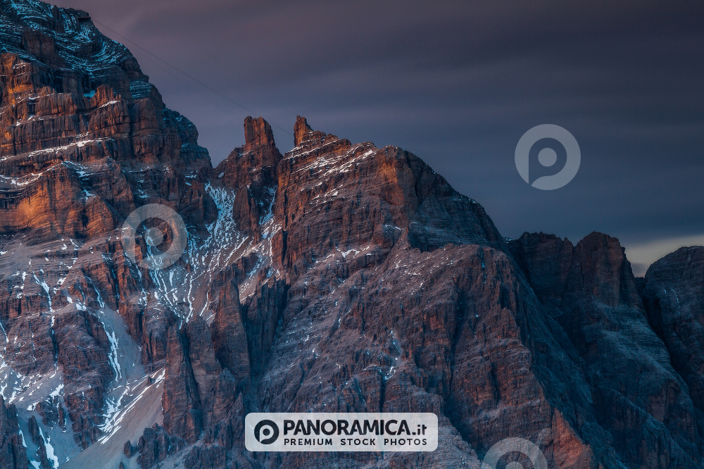 Alpenglow and clouds highlighting Tofana di Rozes from Giau Pass, Cortina d'Ampezzo, Dolomites, Veneto, Italy