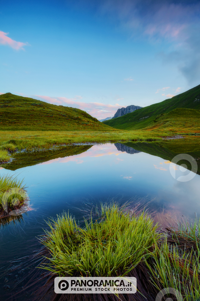 Mulaz Mount reflected in a little alpine lake near the Baita Segantini, Rolle Pass, Dolomites, Trentino Alto Adige, Italy